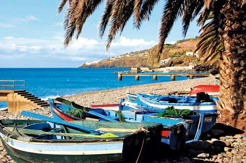 Colourful fishing boats lie on the beach of Santa Cruz, Madeira